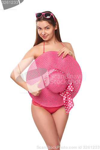 Image of Woman in pink swimsuit and hat