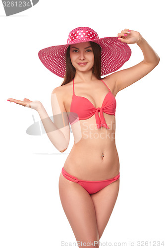 Image of Woman in pink swimsuit and hat