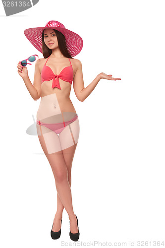 Image of Woman in pink swimsuit and hat