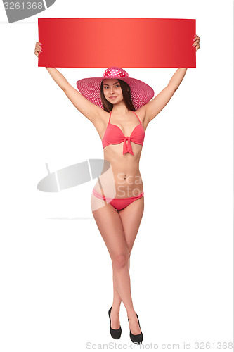 Image of Woman in swimsuit holding red blank cardboard