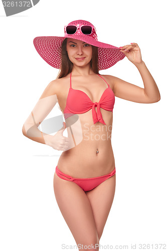 Image of Woman in pink swimsuit and hat