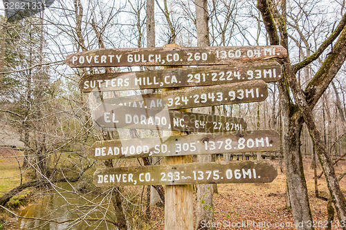 Image of wooden direction sign in the forest