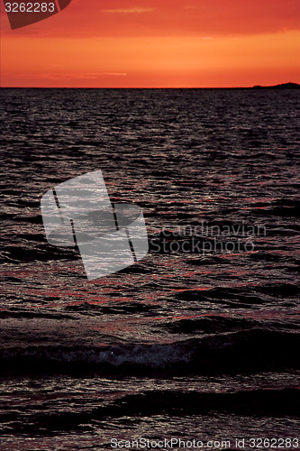 Image of wave in the sunset