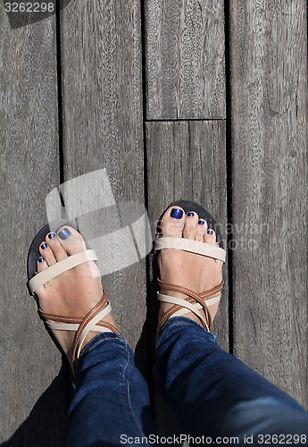 Image of female legs in sandals