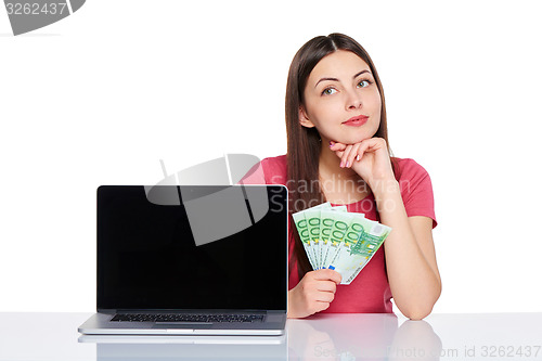 Image of Woman with euro cash showing blank laptop screen