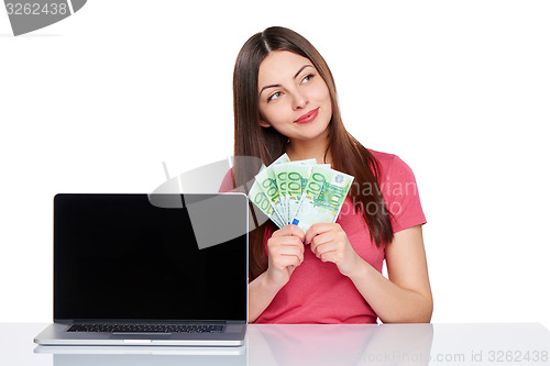 Image of Woman with euro cash showing blank laptop screen