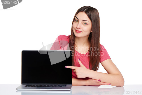 Image of Happy woman pointing at a laptop computer screen