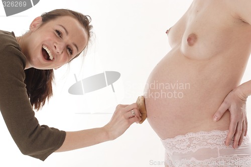 Image of Girl touching pregnant woman's belly