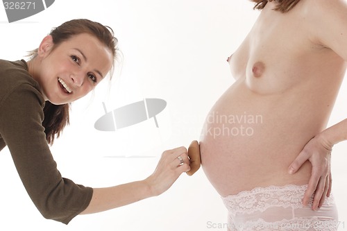 Image of Girl touching pregnant woman's belly