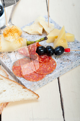 Image of mix cold cut on a stone with fresh pears