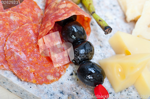 Image of mix cold cut on a stone with fresh pears