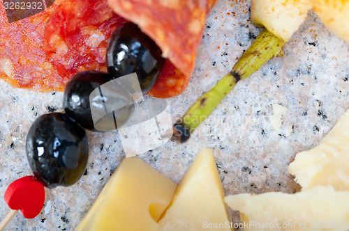 Image of mix cold cut on a stone with fresh pears