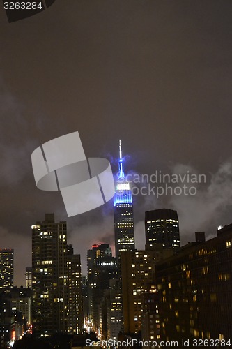 Image of Empire state building between clouds