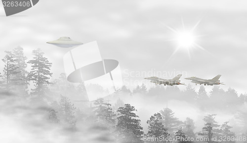 Image of UFO in a landscape of misty forest at sunrise