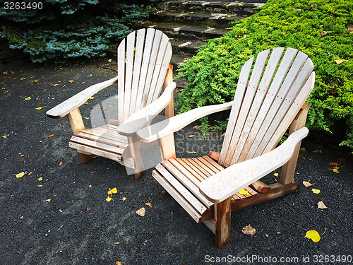 Image of Wooden chairs in autumn garden