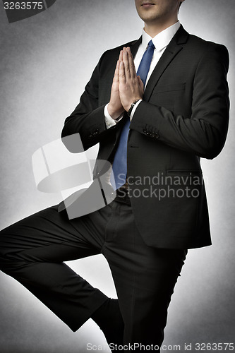 Image of Businessman doing yoga