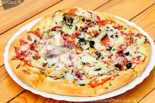 Image of Pizza with pepperoni, black olives and corn