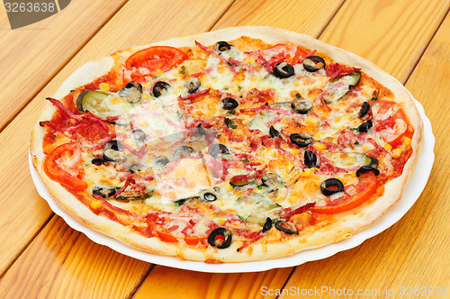 Image of Pizza with pepperoni, black olives and corn