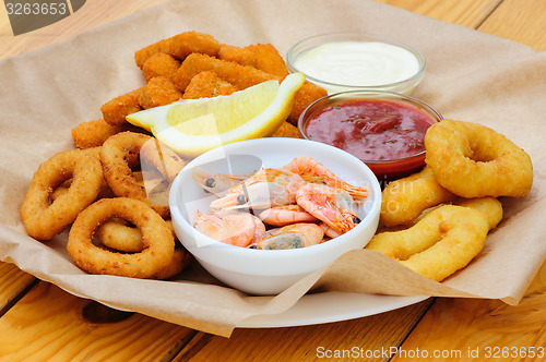 Image of beer snack, shrimps, calmar rings and fish sticks