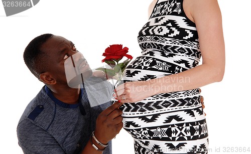 Image of Black man wondering about baby belly.