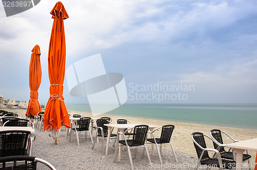 Image of Beach cafe with empty tables and chairs 