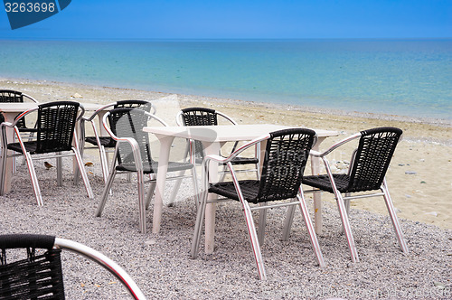 Image of Beach cafe with empty tables and chairs 