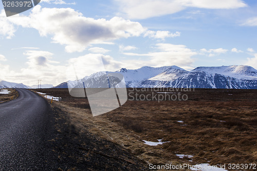 Image of Snowy volcano landscape with dramatic clouds in Iceland