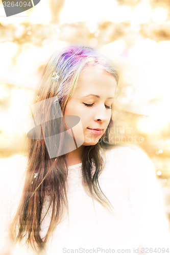 Image of Portrait of cheerful fashionable woman in spring blooming tree
