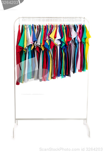 Image of Multicolored clothes on hangers, isolate