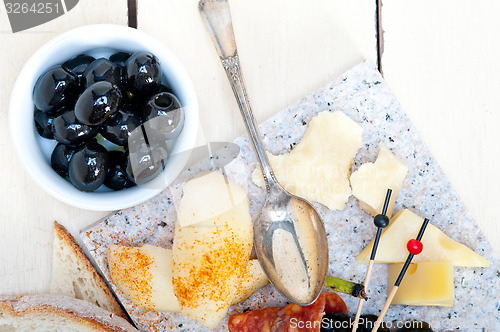 Image of mix cold cut on a stone with fresh pears