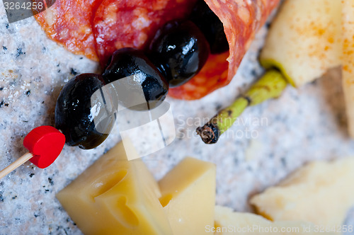 Image of mix cold cut on a stone with fresh pears