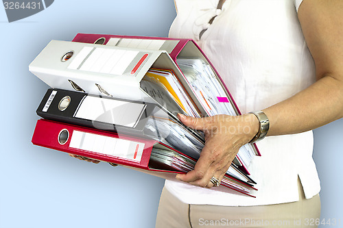 Image of Secretary holding binders