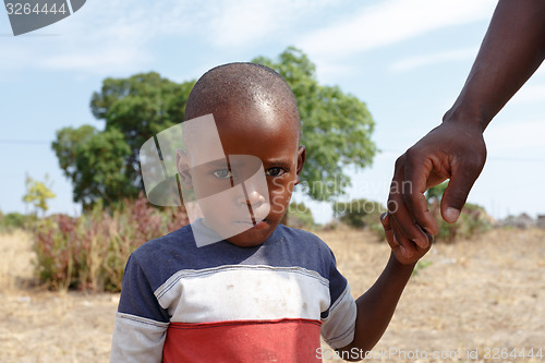 Image of Portrait of Namibian small boy with fathers hand