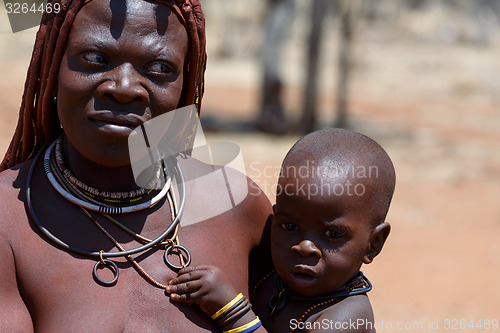 Image of Himba woman with child in the village