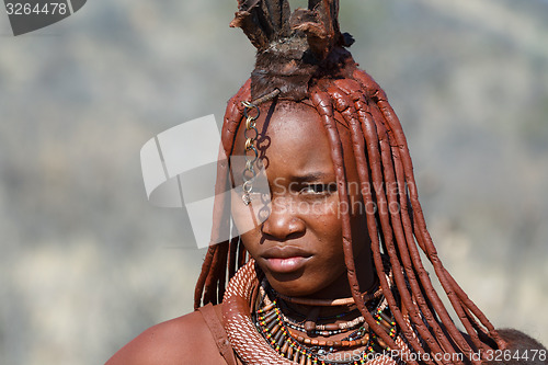 Image of Himba woman with ornament on the neck in the village