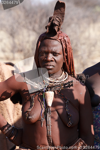 Image of Himba woman with ornament on the neck in the village