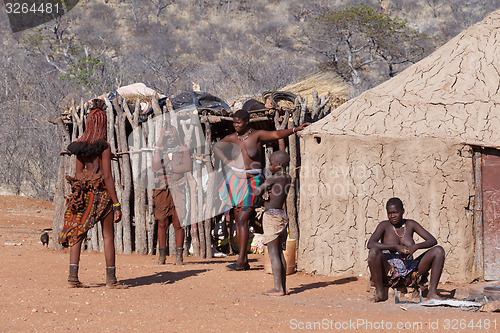 Image of Himba and zemba woman with ornaments on the neck in the village