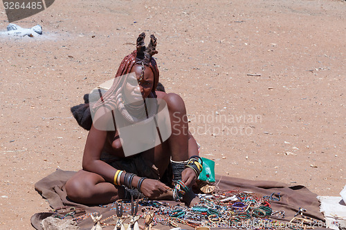 Image of Himba girl with souvenirs for sale in traditional village