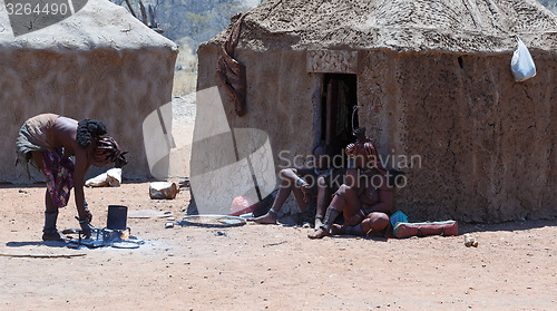 Image of Himba woman with child in the village