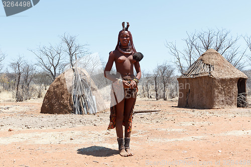 Image of Himba woman with ornament on the neck in the village