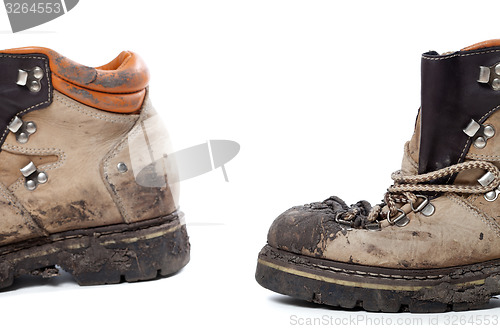 Image of Old dirty hiking boots on white background