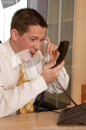 Image of Businessman shouting on phone