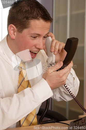 Image of Businessman shouting on phone