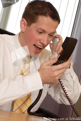 Image of Businessman shouting on phone