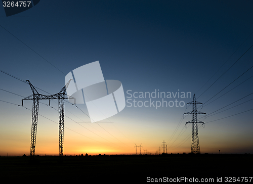 Image of Large transmission towers at sunset