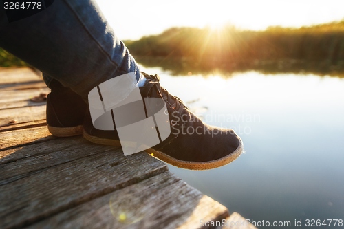 Image of Woman relaxing on jetty