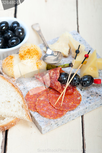 Image of mix cold cut on a stone with fresh pears