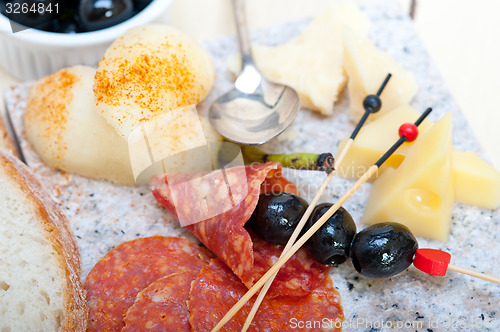 Image of mix cold cut on a stone with fresh pears