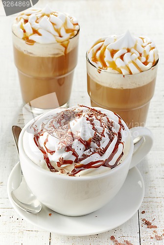 Image of various coffee cups with whipped cream