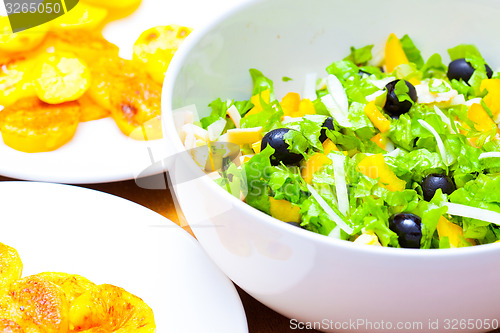 Image of Assorted green leaf lettuce with squid and black olives